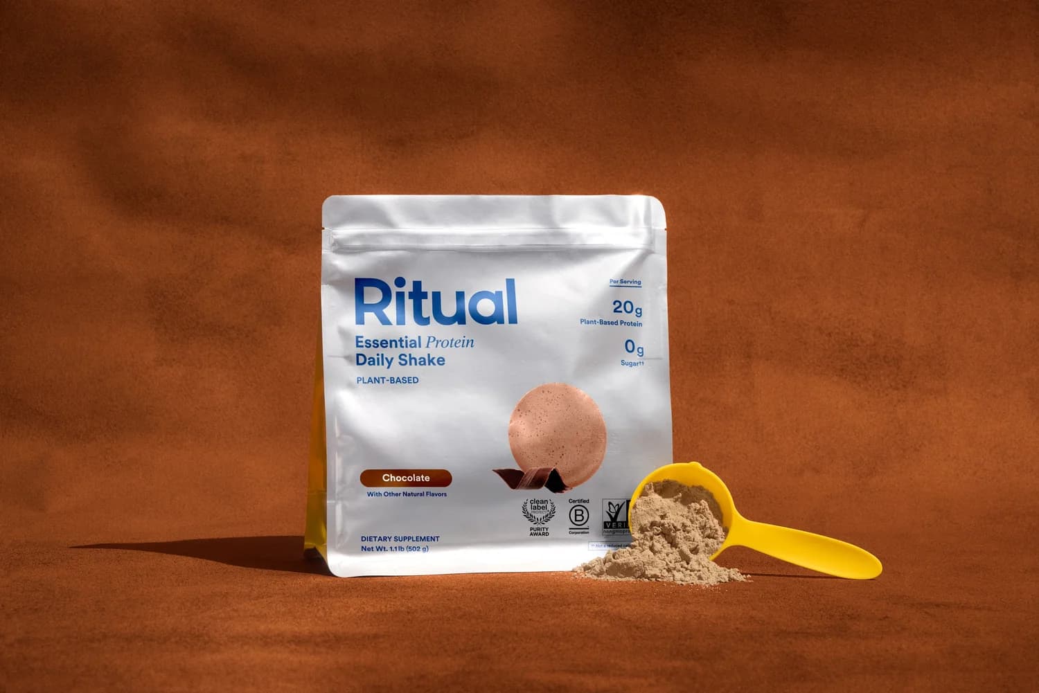 Ritual chocolate protein package on a brown studio backdrop