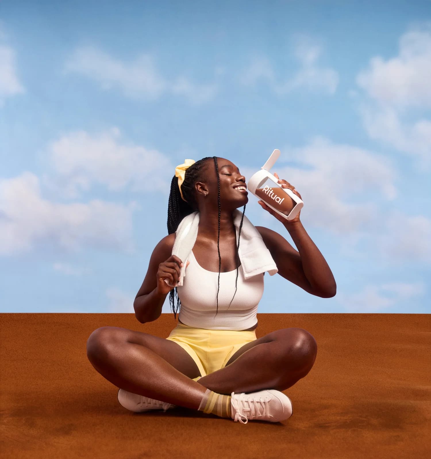 Athlete seated with a Ritual shaker bottle