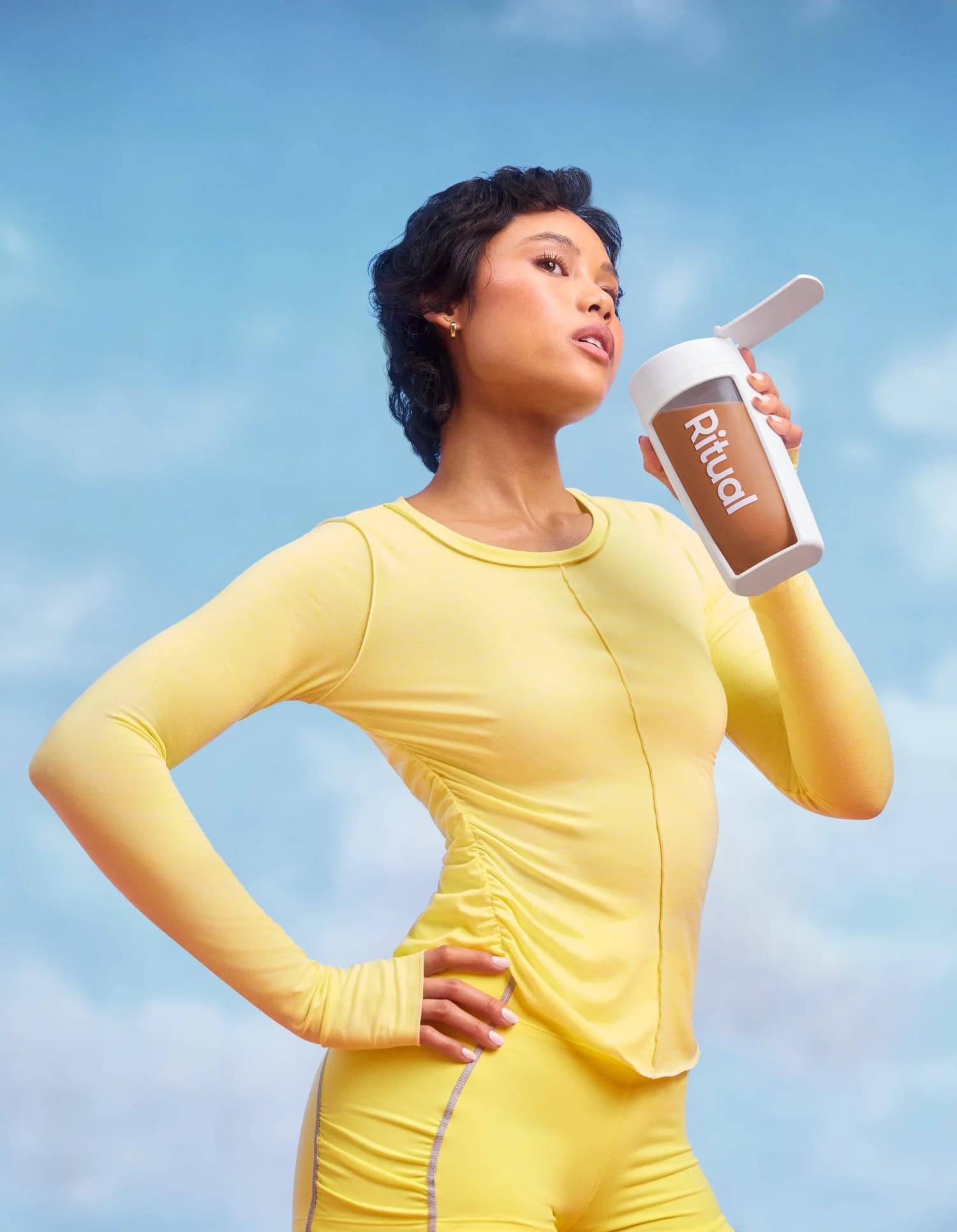 Athlete holding a chocolate protein shaker